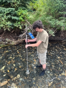 student  taking water sample data in a colorado river