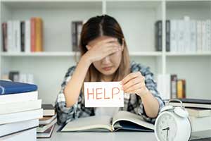 Person holding up help sign.