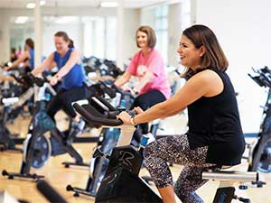 People on stationary bikes in class.