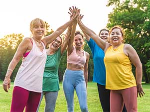 Group in exercise clothing high fiving